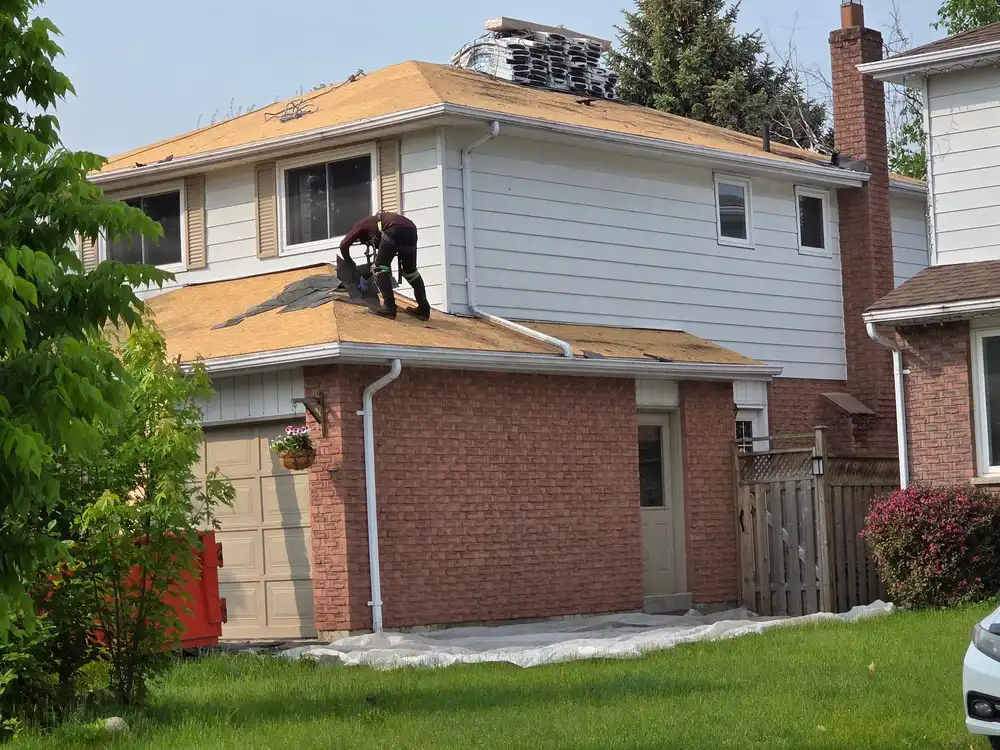 Completed asphalt shingle roof on a two-storey home