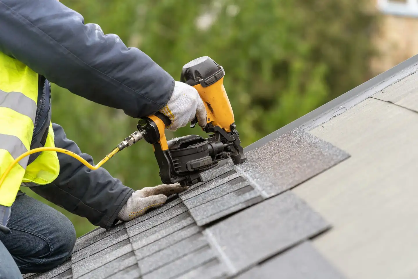 An ELSA Roofing crew’s finished roof against a clear sky